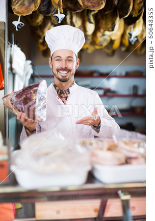 Seller offering piece of meat 60648355