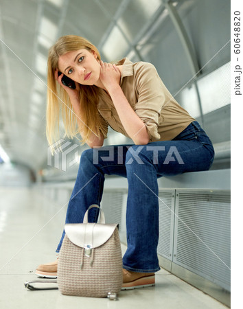 Young woman waiting for train at subway station 60648820