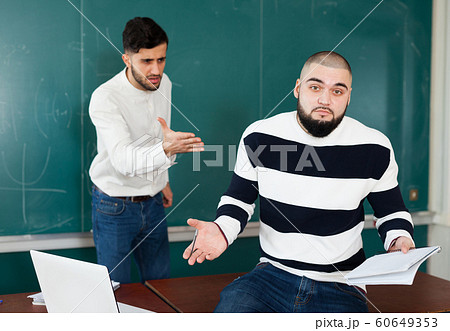 Quarrel between two young male students 60649353