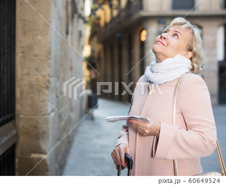 adult woman holding map guide adult woman holding map guide 60649524