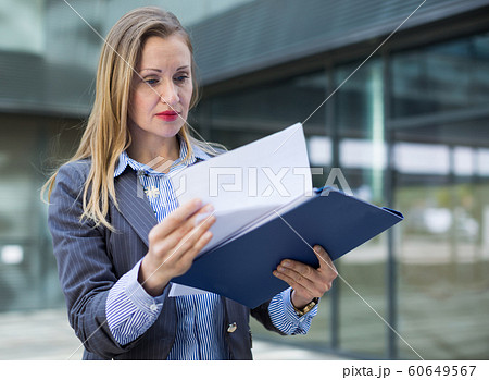 Adult female architect with paper documents 60649567