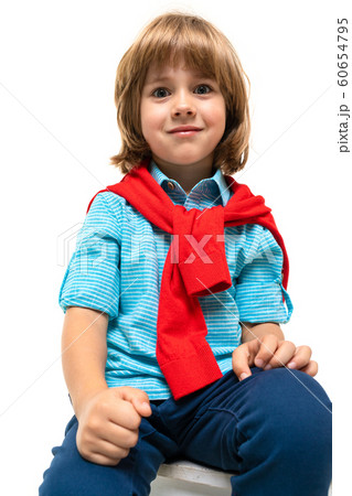 Sports teenager boy in t-shirt with hoody around his neck gesticulates isolated on blue background 60654795