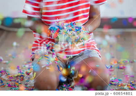 Child girl holding colorful confetti to celebrate in her party 60654801