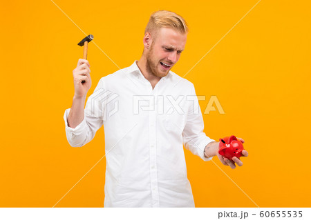 Funny caucasian man have a gift isolated on yellow background Funny caucasian man have a gift isolated on yellow background 60655535
