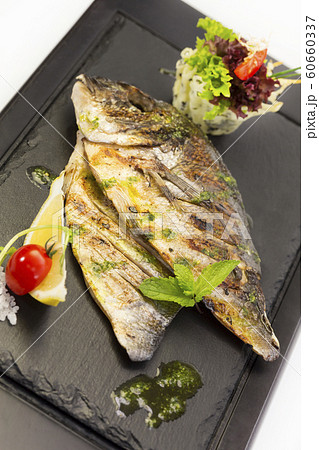 Grilled sea fish. Close-up shot on a white background. 60660337