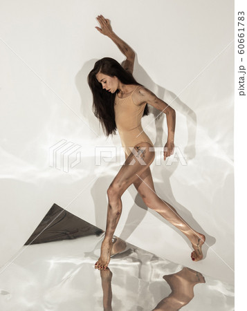 Young and stylish modern ballet dancer on white background with mirrors Young and stylish modern ballet dancer on white background with mirrors 60661783