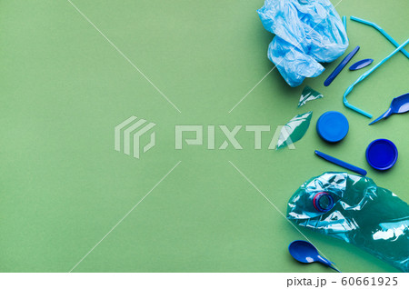 Pile of plastic Garbage isolated on green background 60661925