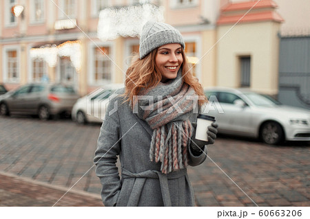 Happy young woman smiling in a trendy coat Happy young woman smiling in a trendy coat 60663206
