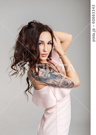 Beautiful young woman with stylish tattoo on hand Beautiful young woman with stylish tattoo on hand 60663343