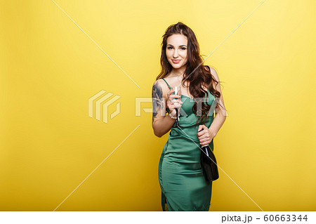 Beautiful young woman in stylish fashionable green Beautiful young woman in stylish fashionable green 60663344