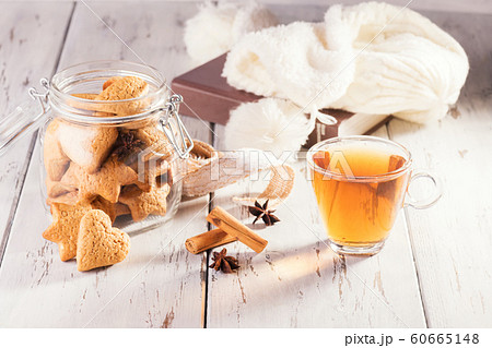 Christmas edible gift: ginger cookies shaped as heart cookies on a shabby natural wooden background. Christmas zero waste. 60665148