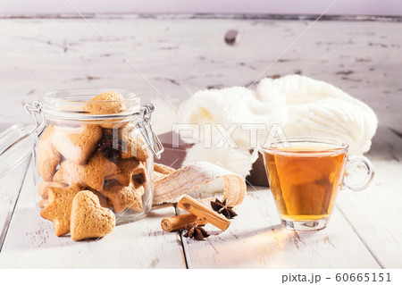 Christmas edible gift: ginger cookies shaped as heart cookies on a shabby natural wooden background. Christmas zero waste. 60665151