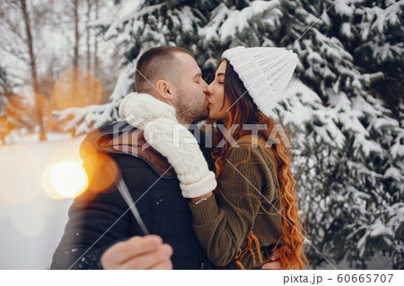 Beutiful woman in a winter park with her husband 60665707