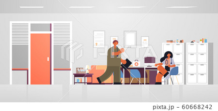 male nurse discussing with female practitioner doctor sitting at workplace desk medicine healthcare concept modern hospital office interior full length flat horizontal male nurse discussing with female practitioner doctor sitting at workplace desk medicine healthcare concept modern hospital office interior full length flat horizontal 60668242