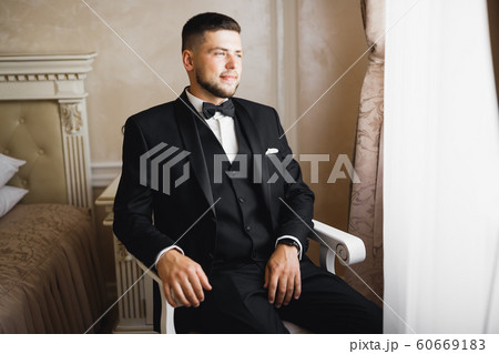 Beautiful man, groom posing and preparing for wedding 60669183