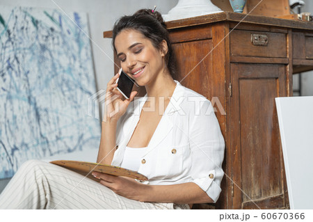 Beautiful woman is talking on mobile phone 60670366