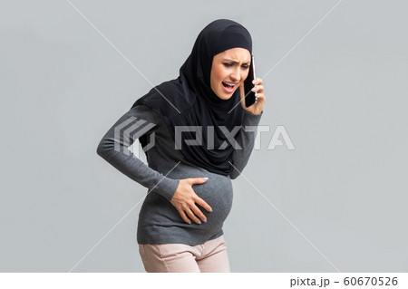Pregnant Muslim Girl Having Contractions,Calling To Doctor, Feeling Unwell Pregnant Muslim Girl Having Contractions,Calling To Doctor, Feeling Unwell 60670526