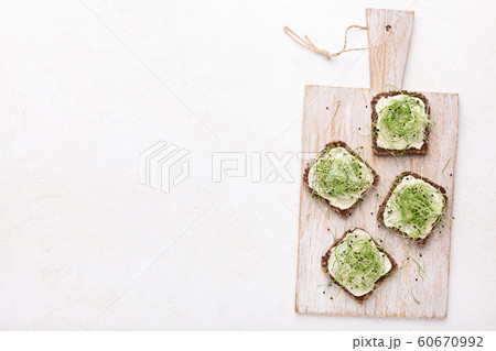 Wholegrain sandwiches with avocado spread, tofu and microgreen Wholegrain sandwiches with avocado spread, tofu and microgreen 60670992