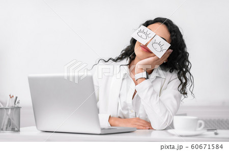 Latin girl sleeping with fake eyes painted on paper stickers Latin girl sleeping with fake eyes painted on paper stickers 60671584