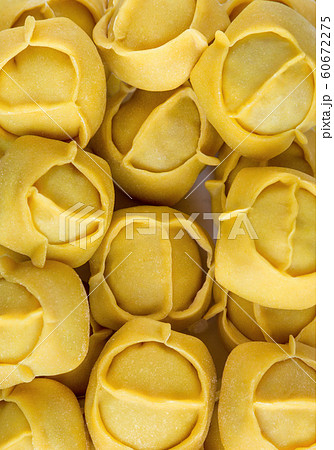 Frozen big yellow dumplings texture in a market fridge Frozen big yellow dumplings texture in a market fridge 60672275
