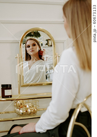 Beautiful woman in her room near her dressing table 60673133