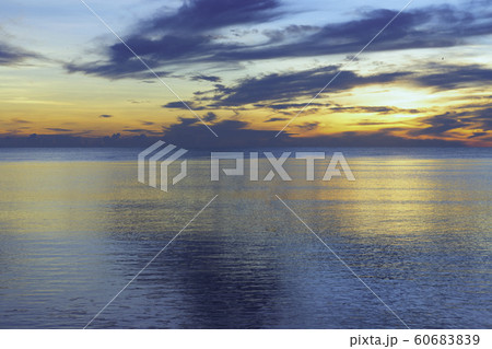 Smooth water surface in the sea and colorful sky in the morning. Smooth water surface in the sea and colorful sky in the morning. 60683839
