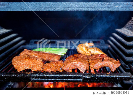 Grilling pork ribs in stove close up 60686845