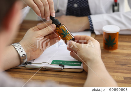 Flask with hush on wooden table 60690603