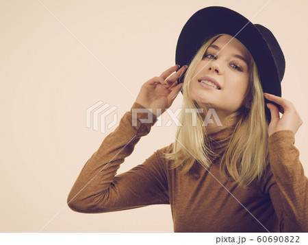 Woman wearing suede and black hat Woman wearing suede and black hat 60690822