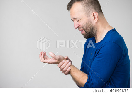 Man feeling pain in wrist Man feeling pain in wrist 60690832