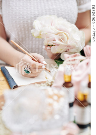 Woman writing ideas for new cosmetics Woman writing ideas for new cosmetics 60693893