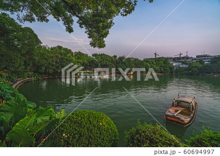 Small wooden boat on Shan Lake in Guilin Small wooden boat on Shan Lake in Guilin 60694997