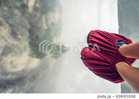 Little tourist girl on a glass walk in China 60695008
