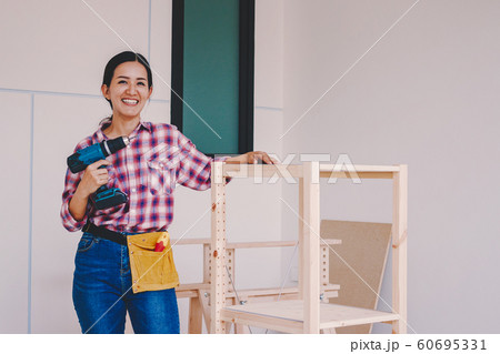 woman worker in the carpenter workroom. 60695331