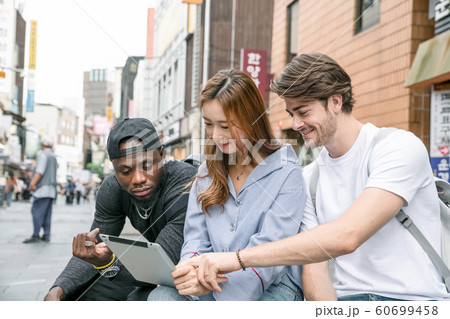 Holidays and tourism concept, group of smiling friends traveling in Seoul, Korea 486 Holidays and tourism concept, group of smiling friends traveling in Seoul, Korea 486 60699458