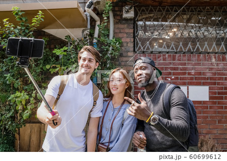 Holidays and tourism concept, group of smiling friends traveling in Seoul, Korea 245 Holidays and tourism concept, group of smiling friends traveling in Seoul, Korea 245 60699612