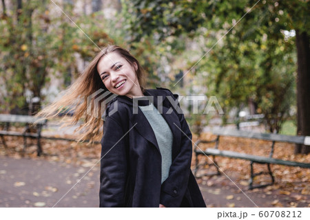 Portrait of stylish smiling happy woman walking in street, positive mood, girl enjoy weekends Portrait of stylish smiling happy woman walking in street, positive mood, girl enjoy weekends 60708212