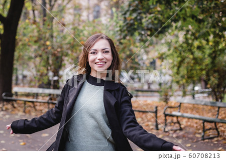 Portrait of stylish smiling happy woman walking in street, positive mood, girl enjoy weekends 60708213