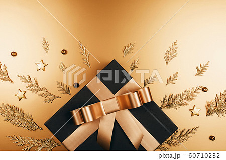 Golden present with decorations. Golden present with decorations. 60710232