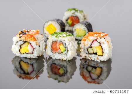 Japanese food sushi rolls uramaki in reflection close-up. 60711197