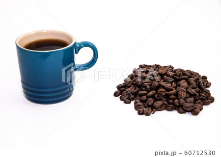 Blue cup of coffee by a pile of coffee beans 60712530