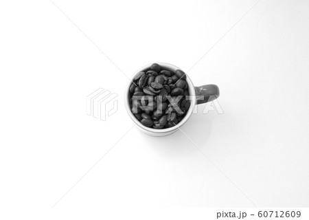Coffee mug filled up with coffee beans 60712609