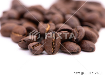 Close up of coffee beans on a white background Close up of coffee beans on a white background 60712636
