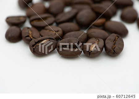 Close up of coffee beans on a white background Close up of coffee beans on a white background 60712645