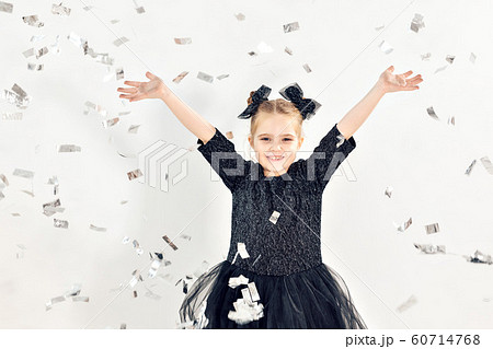 Party, holidays, new year and celebration concept - Female child throwing confetti. Party, holidays, new year and celebration concept - Female child throwing confetti. 60714768