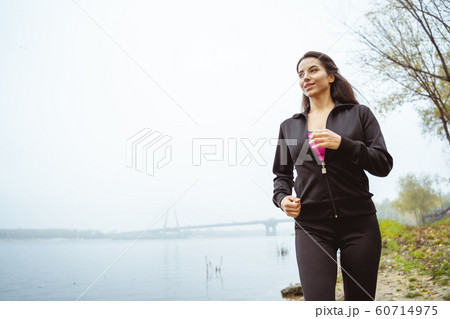 Positive delighted female person doing morning activity 60714975