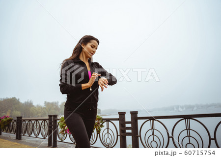 Concentrated brunette female spending her morning outside Concentrated brunette female spending her morning outside 60715754