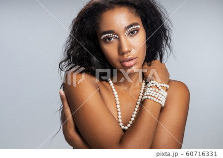 Beautiful woman with startling makeup looking at camera 60716331