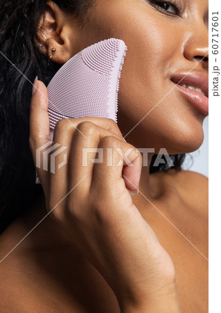 Cropped photo of Afro American lady keeping silicone brush for face in her hand 60717601