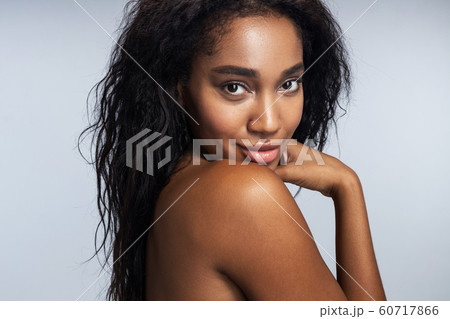 Young Afro-American woman is posing in studio 60717866
